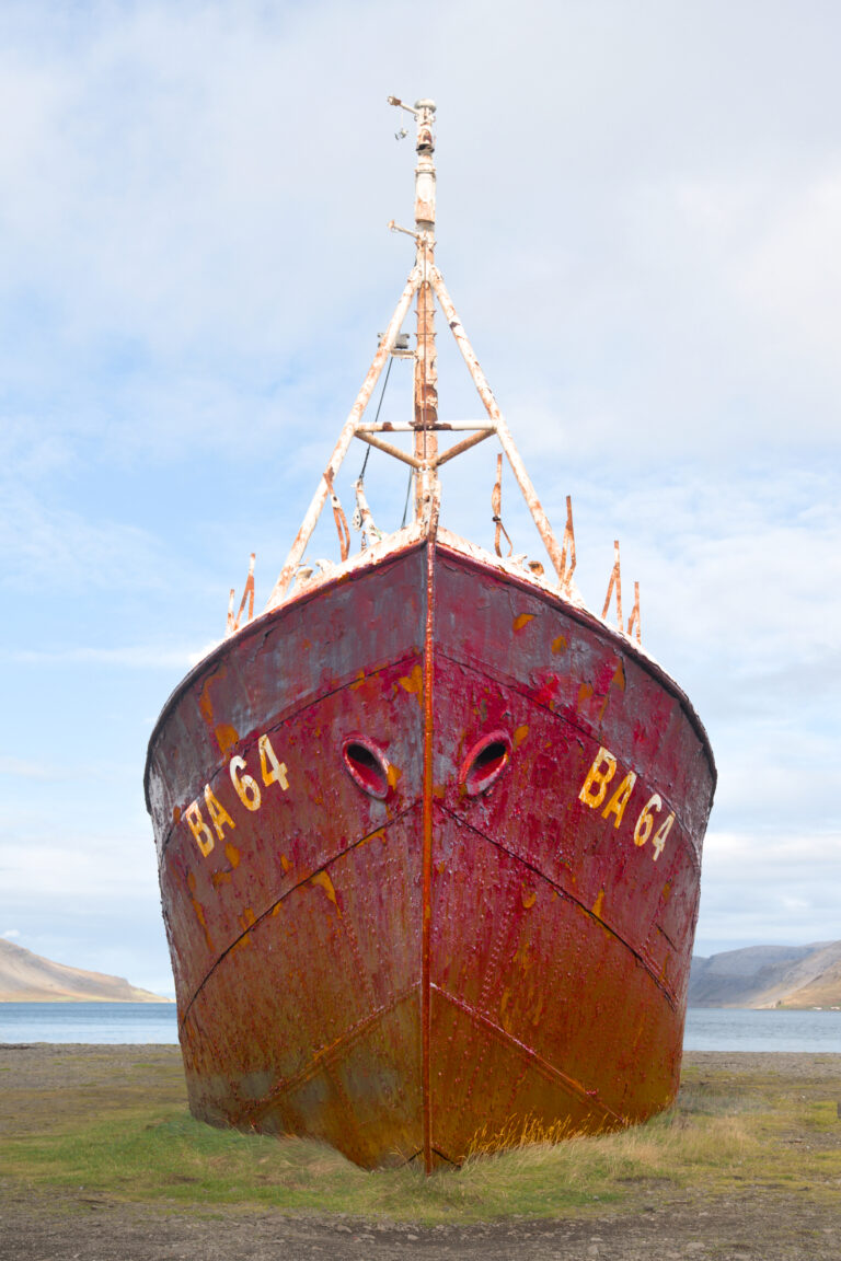 Front view of beached rusting fishing boat